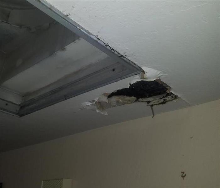 Hole in the ceiling created by a water leak